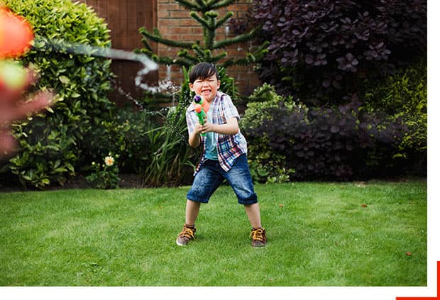 active provider having water fight with child