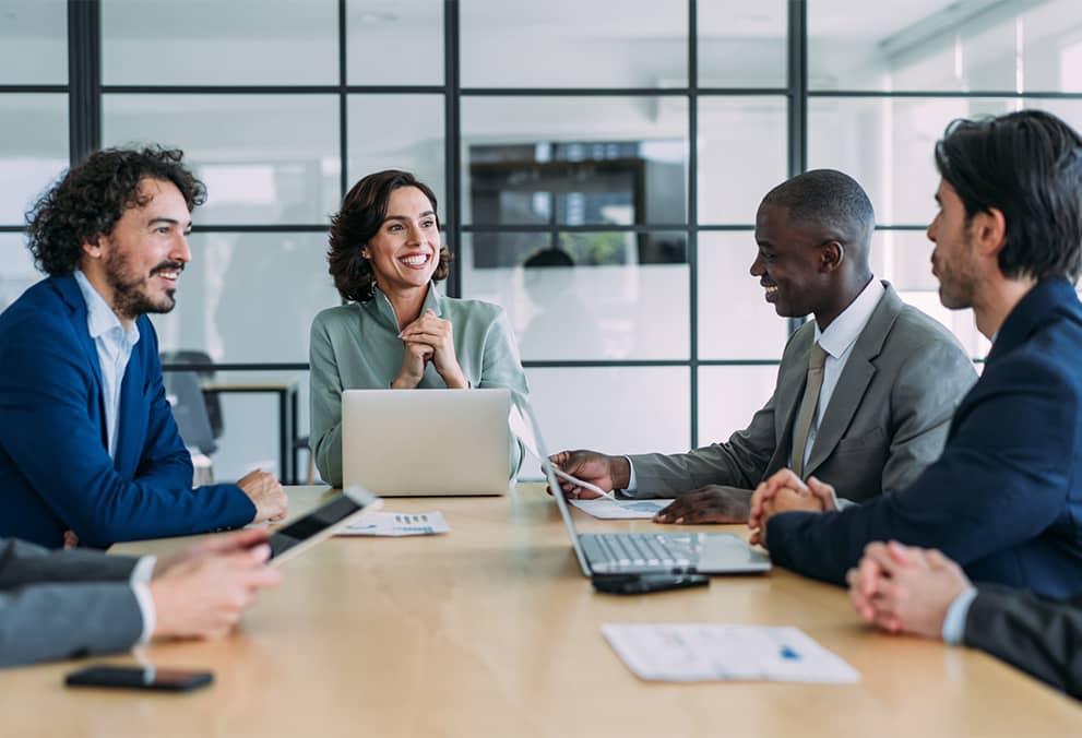 Group of associates sitting at table together