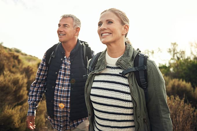 Couple discovering nature on a hike while enjoying their financial security