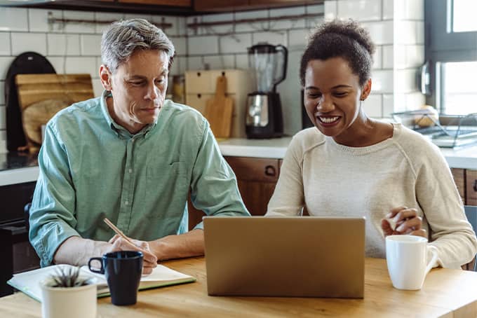 Couple researching retirement annuity options on computer
