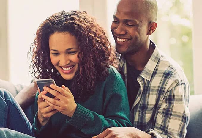 Couple using phone together