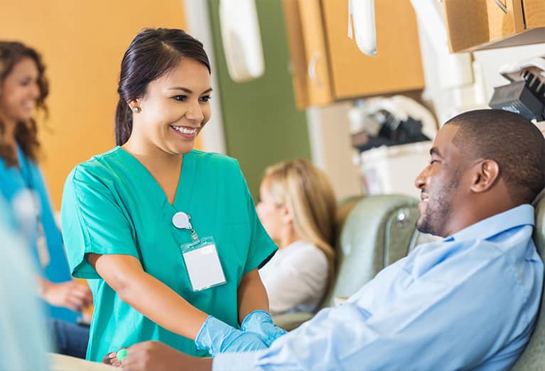 Man talking with nurse while donating blood