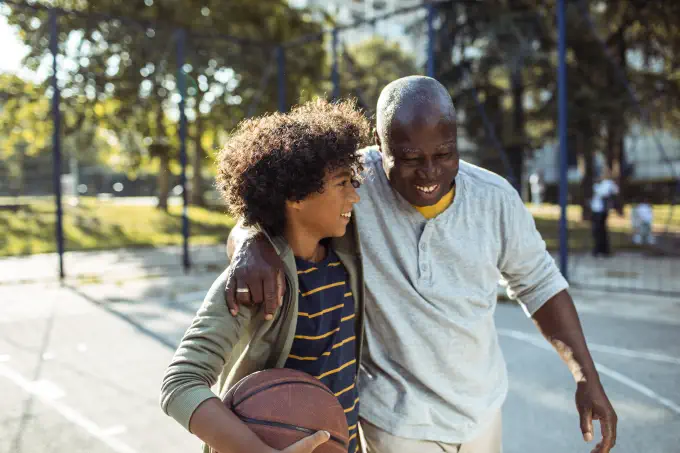 father and son playing basketball together