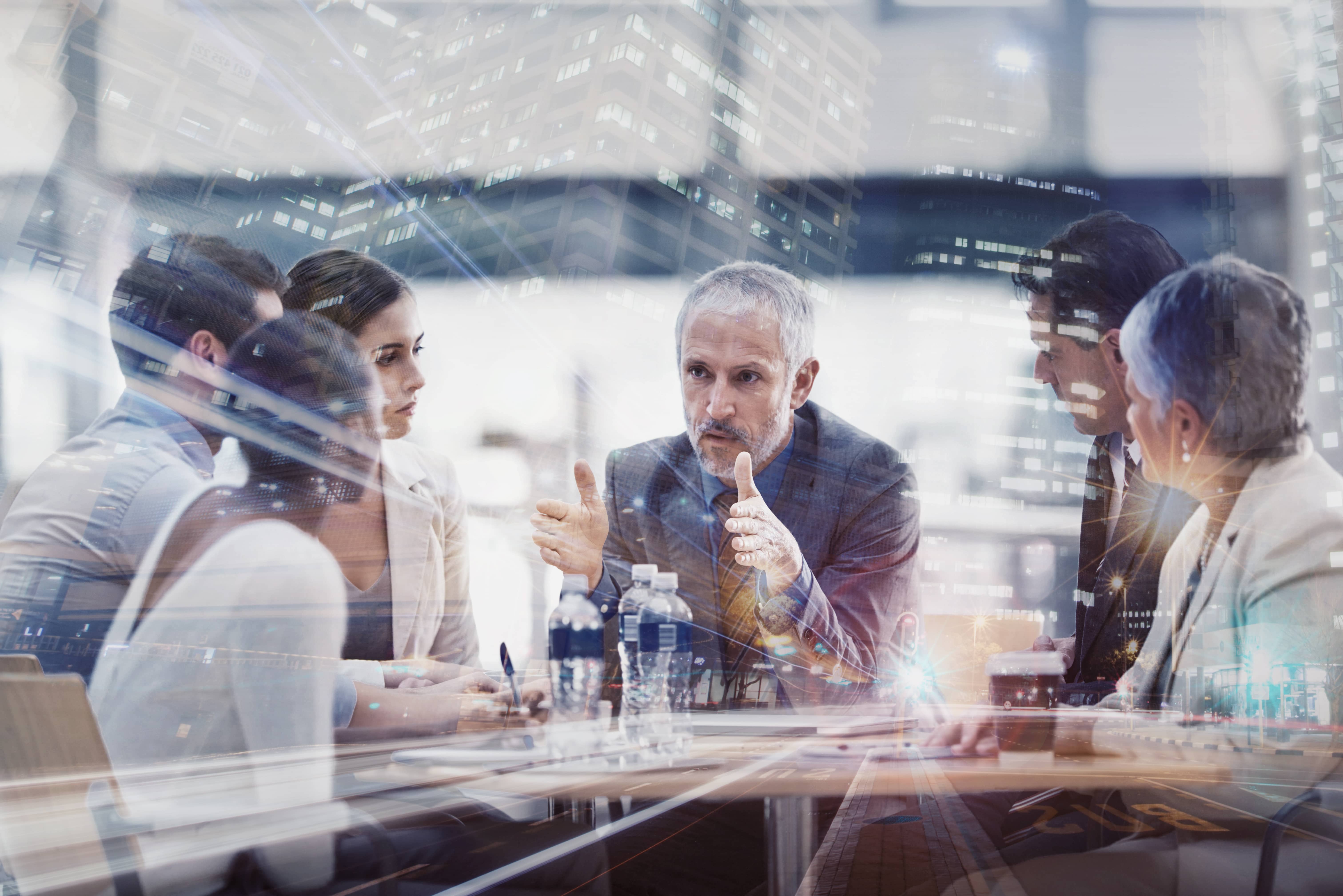 Business team collaborating with a glimpse of the city.