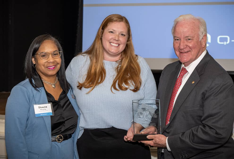 Barrett standing with Hawkins award winner