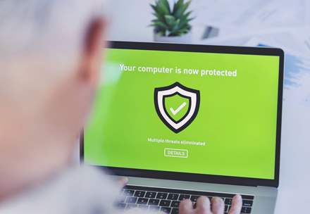 Businessman installs antivirus software.