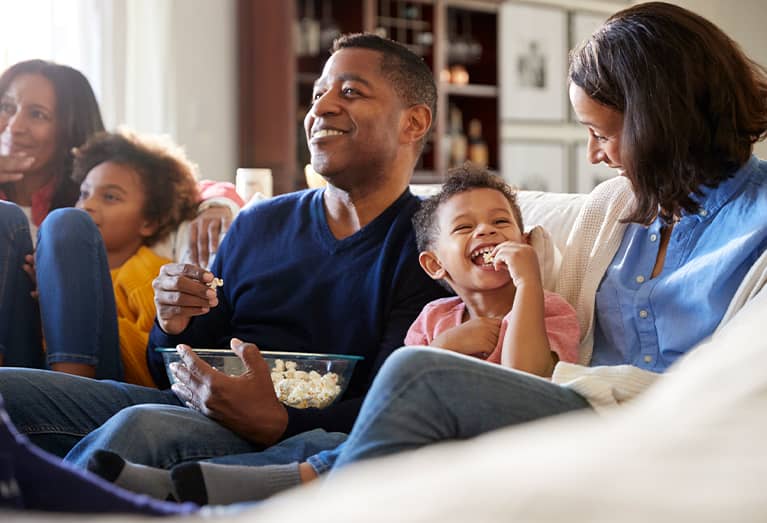 Large family sitting together in living room