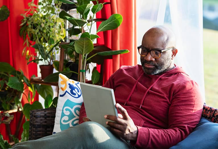 Man researching guaranteed whole life insurance on a tablet