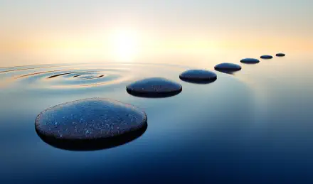 Stones in calm water with evening sun with horizon. Tranquil scenery.