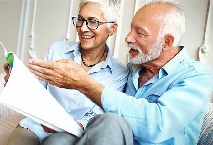 Married couple reading a magazine together