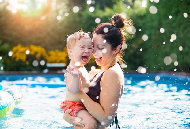 Mother and child swimming in pool