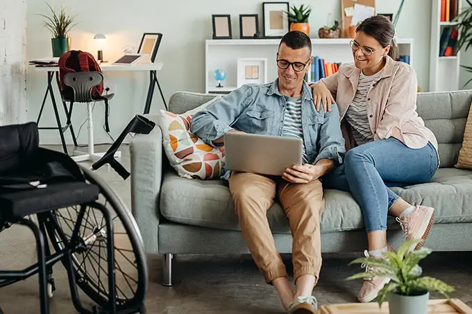 couple looking at laptop on couch