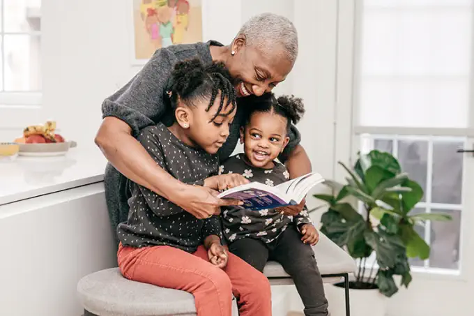 grandmother reading to granddaughters