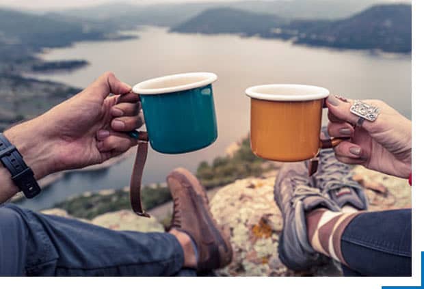 prideful explorer drinking from cup with partner