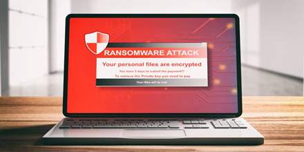 Ransomware attack message on laptop.