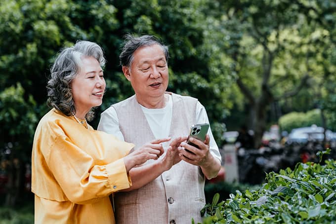 Retired couple reviewing annuity options on phone