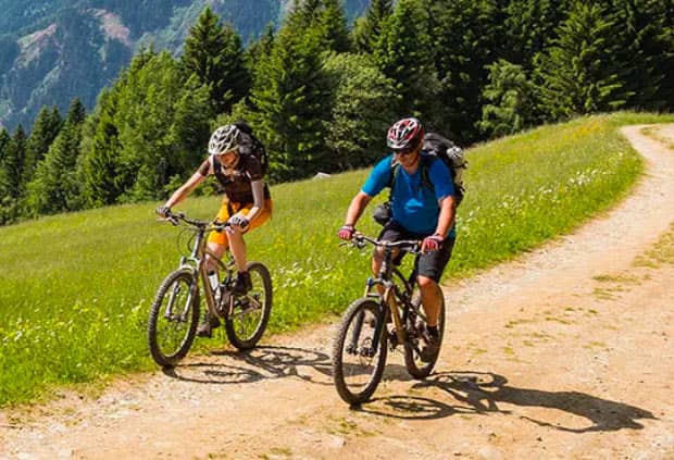 couple riding a bike thinking about retirement planning