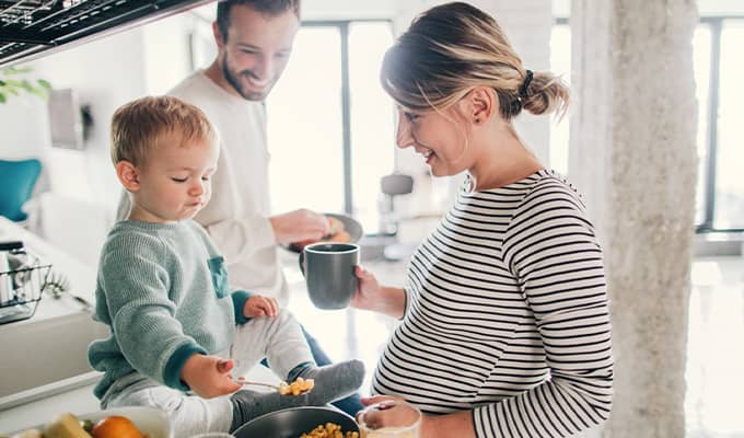 Young family cooking together with toddler