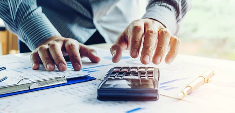 Hands and calculator