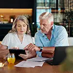 Couple researching guaranteed whole life insurance
