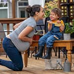 Pregnant mother thinking about life insurance options