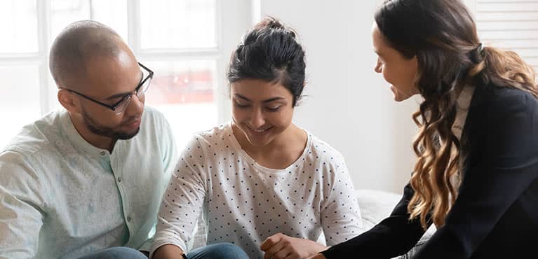 Couple discussing life insurance with their advisor