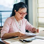 Retired woman checking her monthly budget