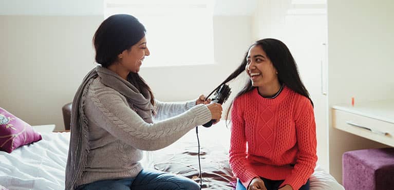 mother helping daughter with hair seeing benefits whole life insurance