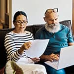 Couple budgeting together on the couch