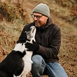Man hiking outdoors with his dog