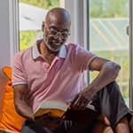 Retired man reading on couch