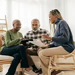 Parents reviewing insurance policy with daughter
