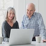 Retired couple researching annuities online