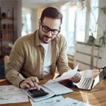 Young man working on his household budget