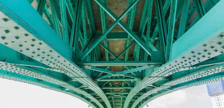 steel lines under a bridge