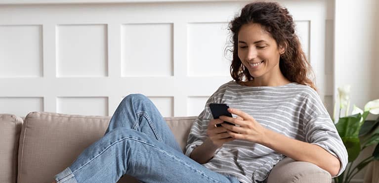 Young woman reading on her phone
