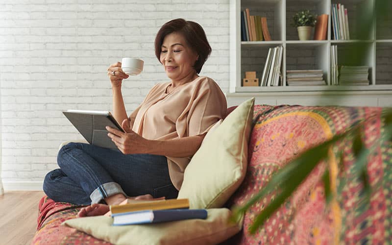 Woman going over assets on the couch - leaving a legacy