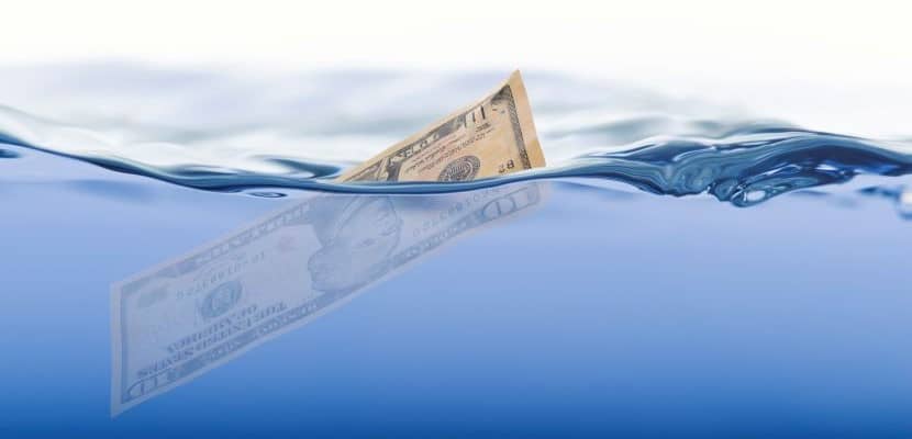 Ten dollar bill in water. Liquidity concept.