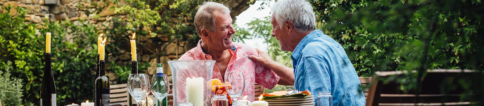 two men laughing at dinner party