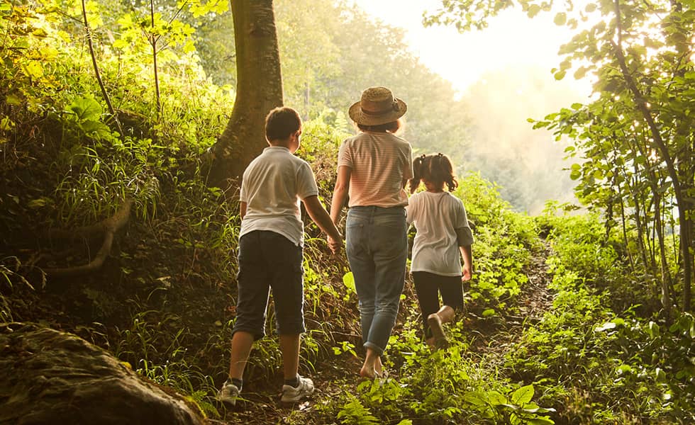 Mother and children enjoying nature knowing that they're financially protected