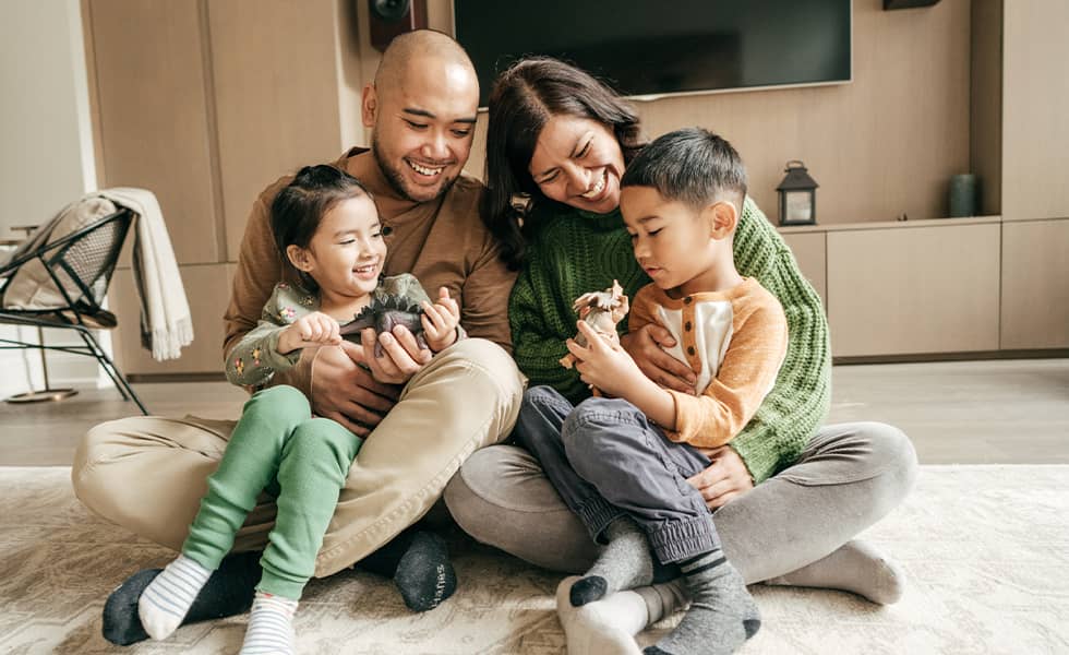 Family sitting on living room floor
