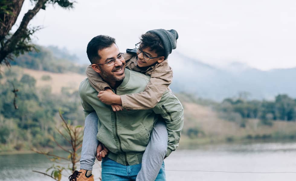 Father carrying son on his back