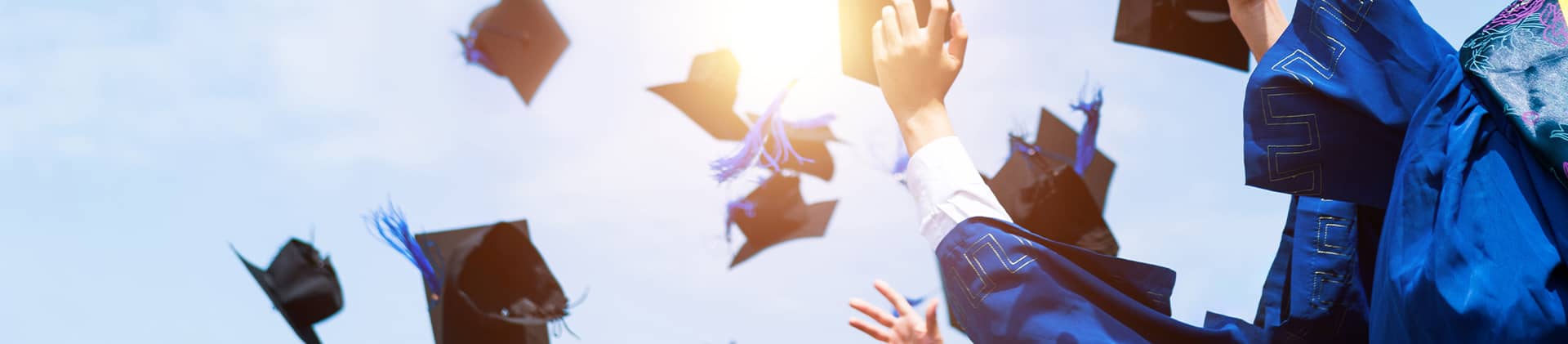 College graduates throwing their caps in the air