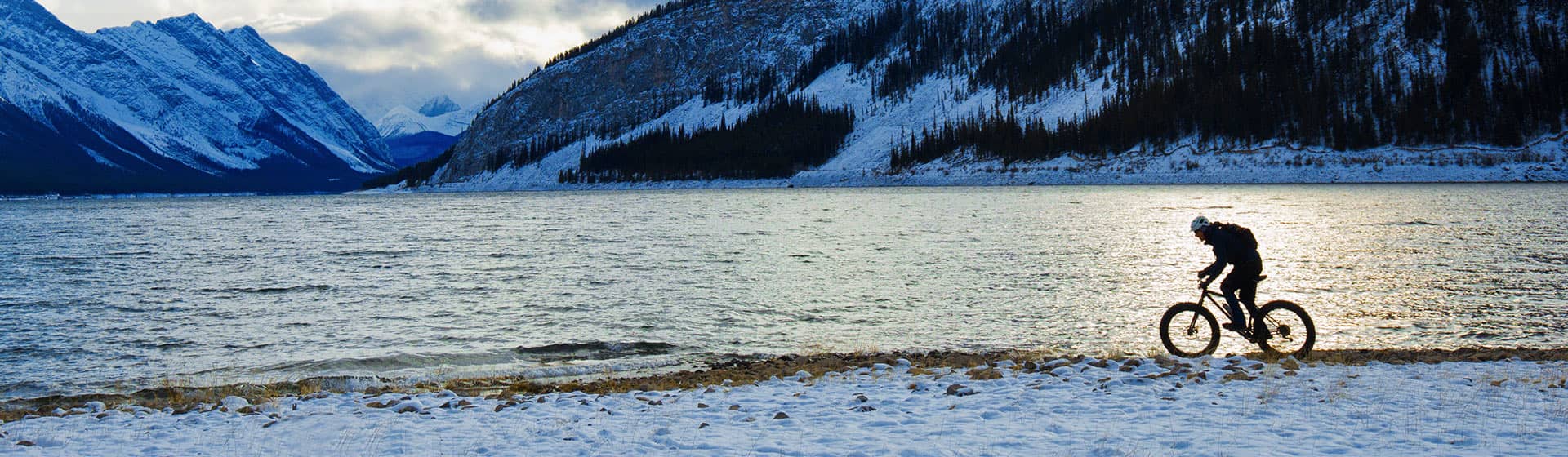 Biker riding in winter landscape