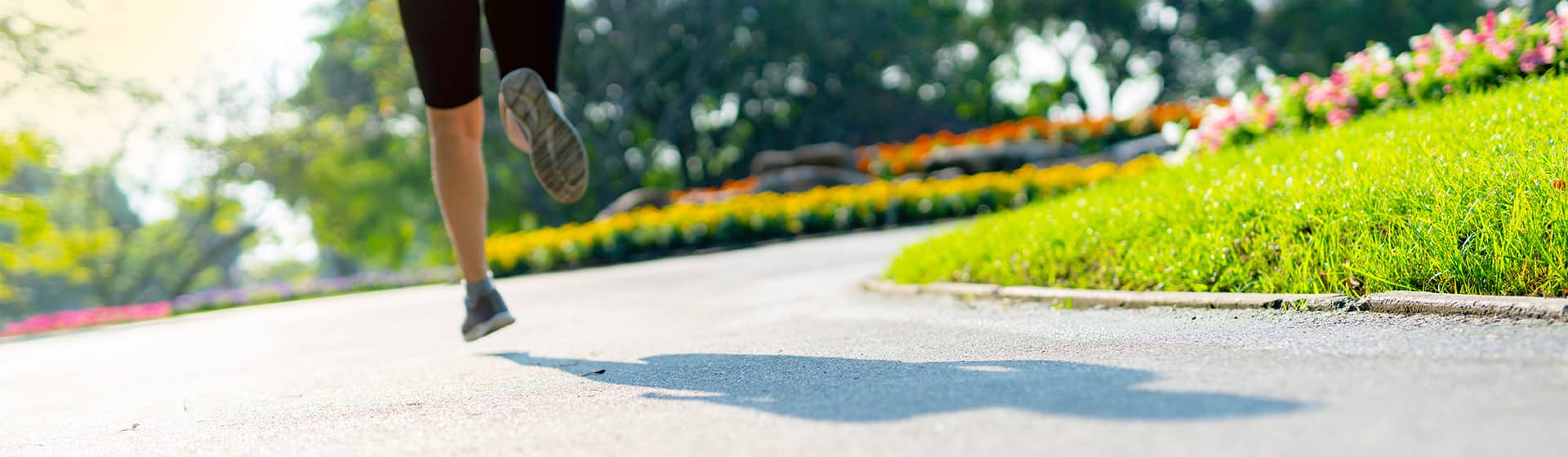 Woman running in a park outdoors in the summer