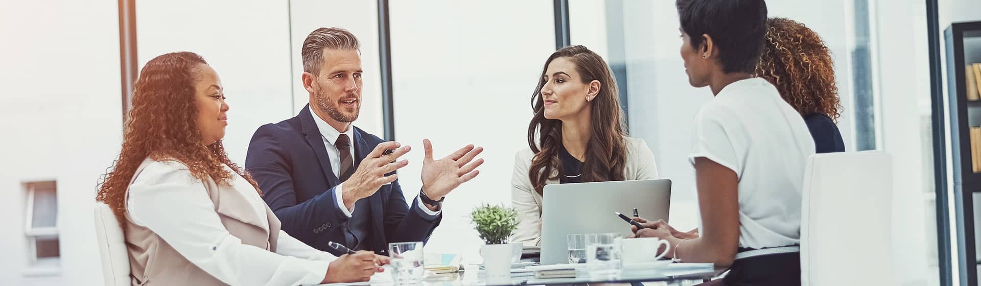 5 professional workers discussing the days agenda