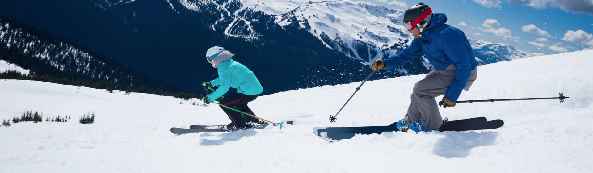 Couple skiing in snowy mountains