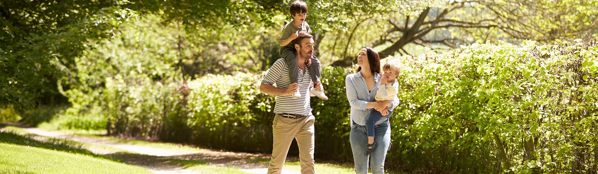 Family of four walking in the summer countryside