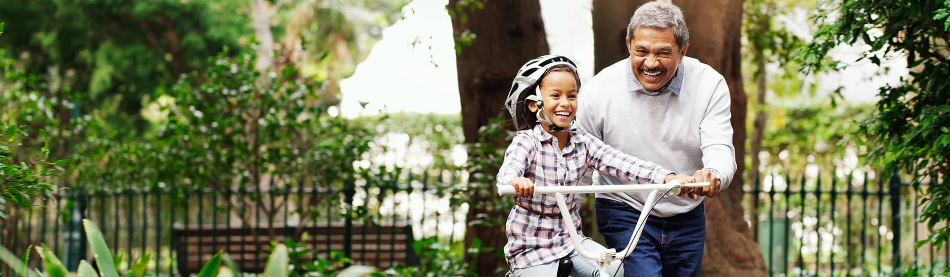 grandfather teaching to ride bike