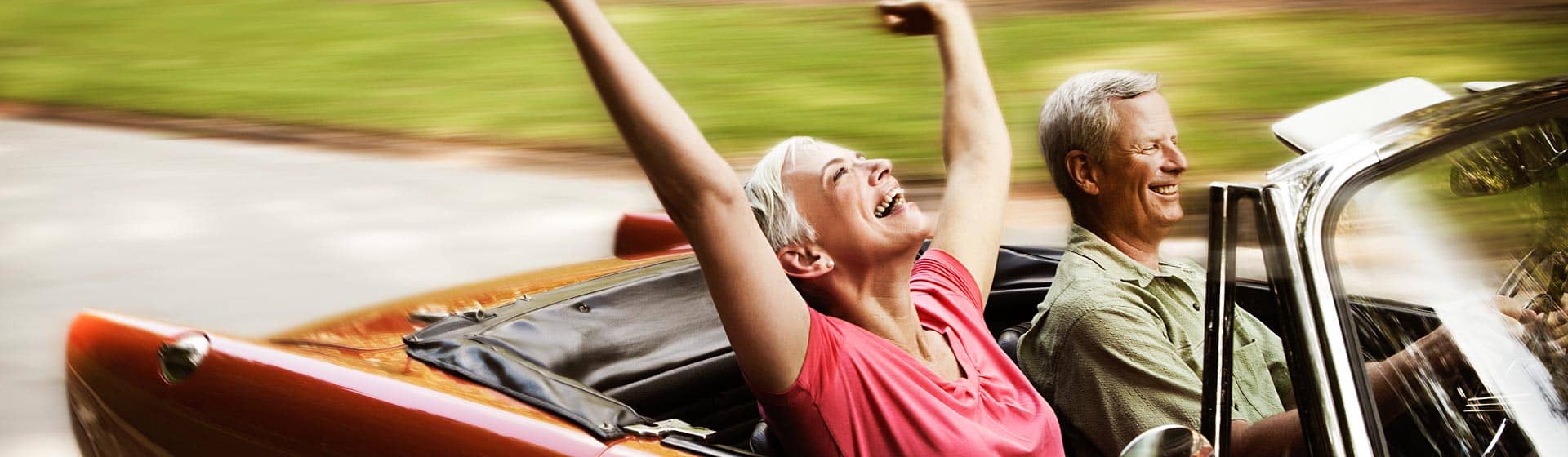 Happy couple driving in a convertible